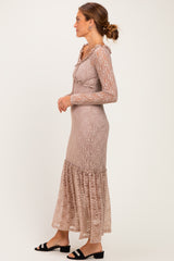 woman wearing a taupe long sleeve lace dress with ruffled details and a flared hem, styled with black sandals