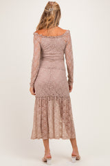 woman wearing a maternity lace long sleeve dress in a soft taupe color with a ruffled hem, viewed from the back