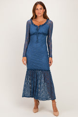 woman wearing a blue lace long sleeve maxi dress with a ruffled hem and a fitted bodice