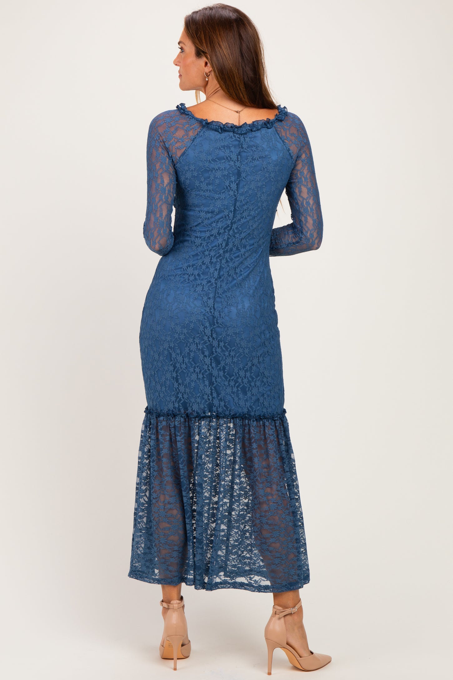 woman wearing a blue lace maxi dress with long sleeves and a flared hem, shown from the back