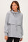 woman wearing a grey cowl neck sweatshirt with long sleeves and a relaxed fit
