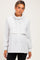 woman wearing a light grey maternity sweatshirt with a cowl neck and layered front detail