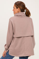 woman wearing a taupe cozy cowl neck sweatshirt with a stylish layered back detail