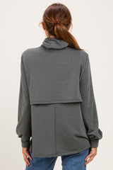 woman wearing a gray long sleeve hoodie with a layered design and a relaxed fit, viewed from the back