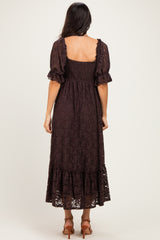 woman wearing a chocolate brown lace maxi dress with short puff sleeves and a tiered skirt, viewed from the back