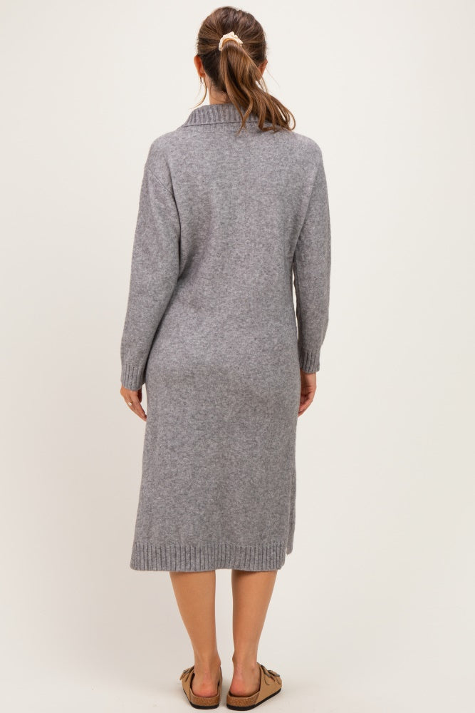 woman wearing a gray long sleeve maternity sweater dress, viewed from the back