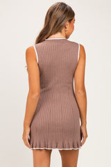 woman wearing a brown sleeveless ribbed maternity dress with a ruffled hem and white trim, showing her back