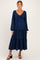 woman wearing a navy blue tiered maternity dress with long sleeves and a tie front detail, showcasing a baby bump