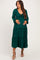 woman wearing a dark green maternity dress with a tie front and tiered skirt, holding her baby bump