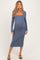 woman wearing a blue long sleeve maternity dress with a square neckline and visible baby bump