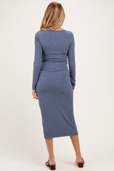 woman wearing a fitted ribbed maternity midi dress in slate blue, view from the back, ideal for expecting mothers