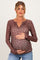 woman wearing a brown floral maternity top and holding her baby bump