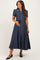woman wearing a navy blue floral maternity dress with short sleeves and a tie waist, showcasing her baby bump