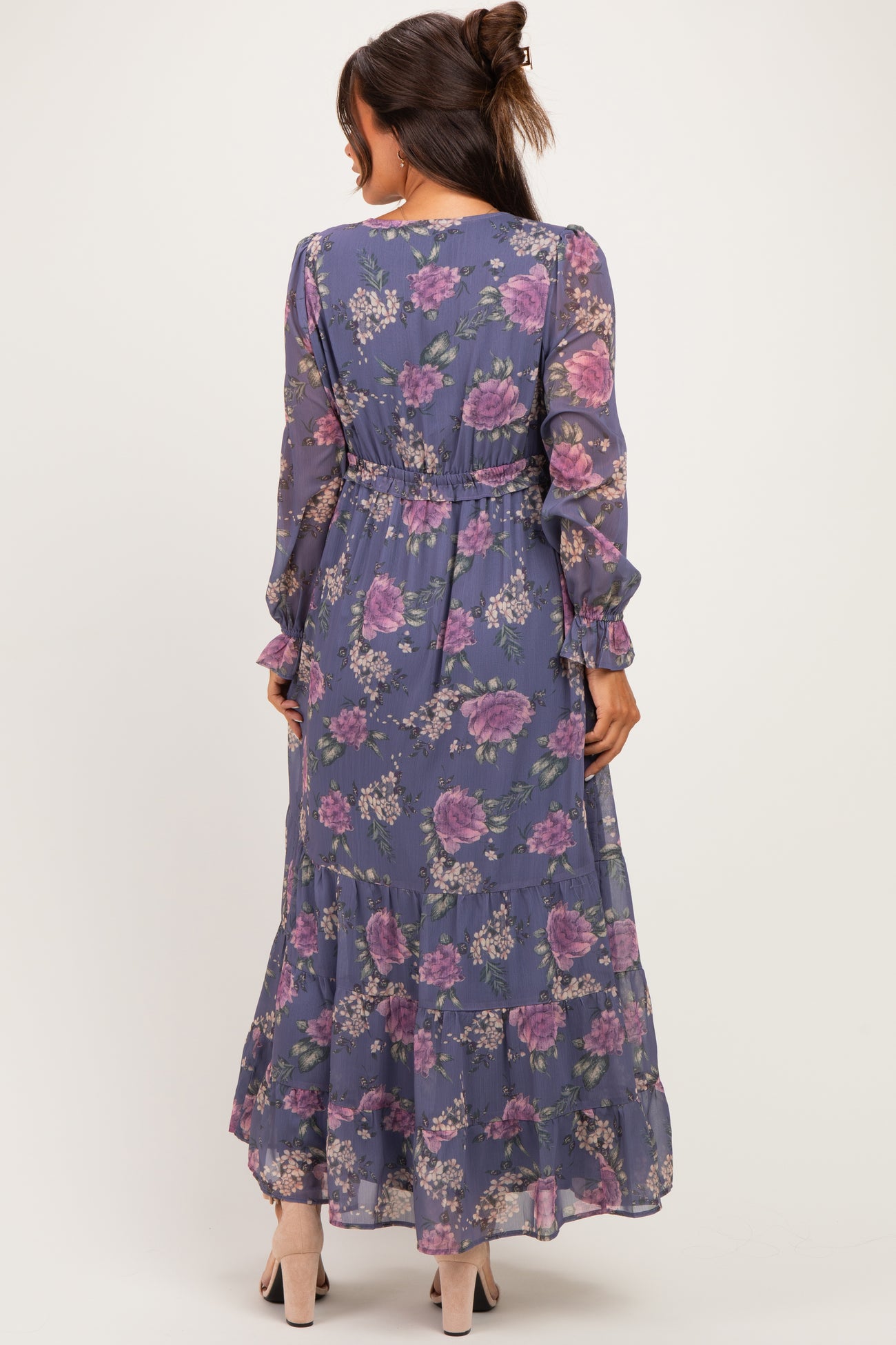 woman wearing a floral maternity maxi dress with long sleeves and a tiered skirt, showcasing a relaxed fit