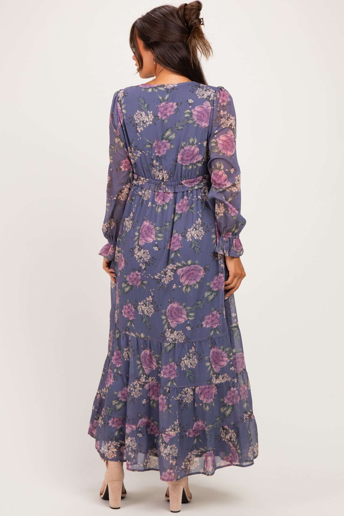 woman wearing a floral maternity maxi dress with long sleeves and a tiered skirt, showcasing a relaxed fit