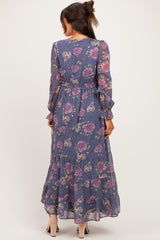 woman wearing a floral maternity maxi dress with long sleeves and a tiered skirt, showcasing a relaxed fit