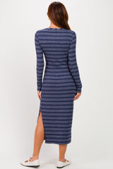 woman wearing a navy and white striped long sleeve midi dress with a side slit