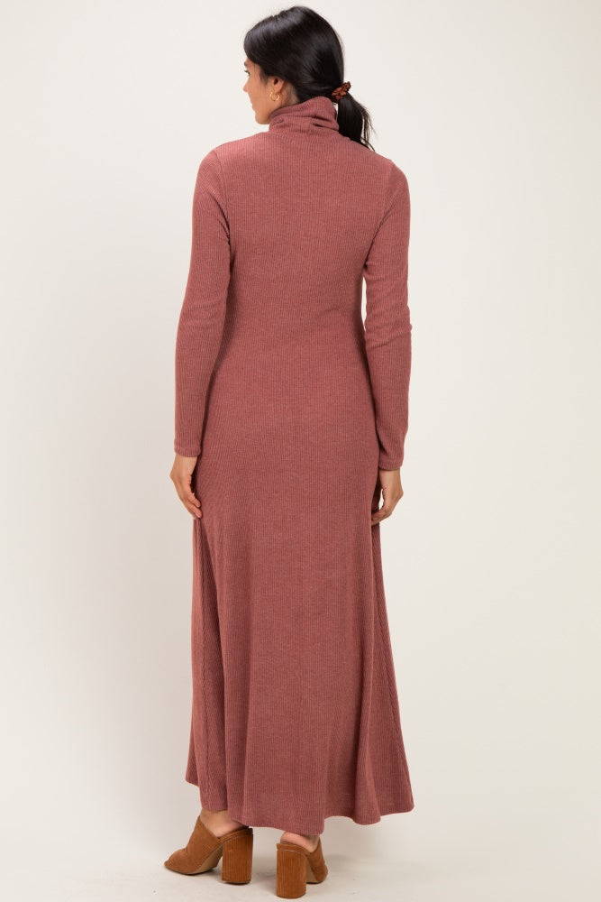 woman wearing a rust-colored long sleeve ribbed maxi dress with a turtleneck and open back