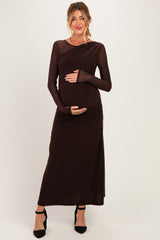 woman wearing a brown long sleeve maternity dress and holding her baby bump
