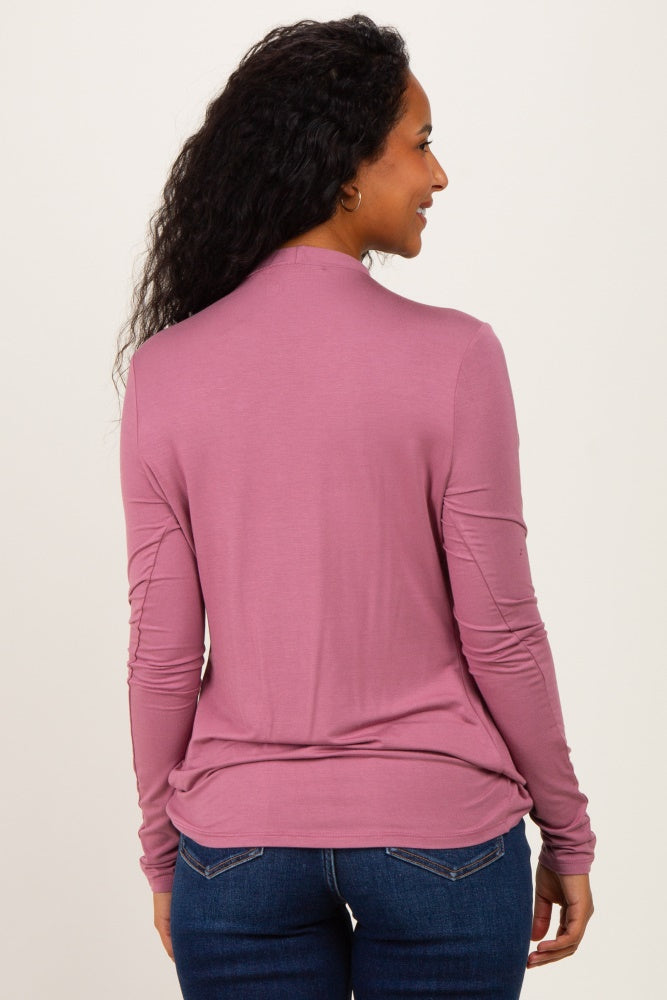 woman wearing a soft pink long sleeve maternity top, shown from the back, with a relaxed fit and rounded hem