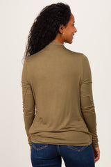 woman wearing an olive green long sleeve maternity top, showing the back view and styled with fitted jeans
