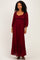 woman wearing a burgundy long sleeve lace maxi dress with a square neckline and ruffle hem