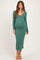 woman wearing a green ribbed v-neck maternity dress showing her baby bump