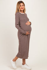 woman wearing a brown and cream striped maternity dress and holding her baby bump