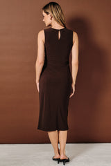 woman wearing a brown sleeveless midi dress with a keyhole back detail, shown from the back