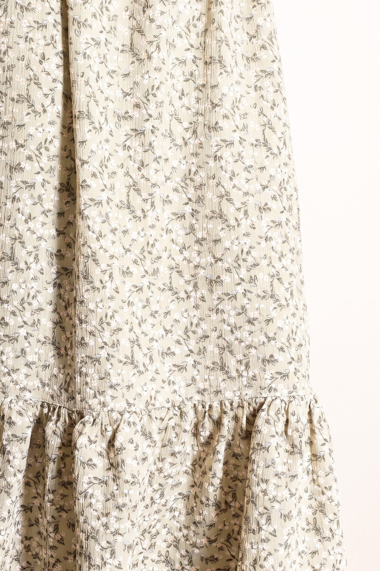 floral print midi dress in cream with ruffled hem and gathered detailing