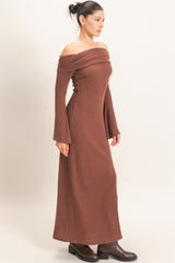 woman wearing a brown off-the-shoulder ribbed maxi dress with bell sleeves and side slits