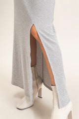 gray ribbed maxi dress with side slits, paired with white ankle boots