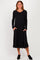 woman wearing a black long sleeve midi dress with pockets and a relaxed fit
