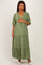 woman wearing a light green maternity maxi dress with short sleeves and lace trim details, posing with a relaxed smile