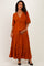 woman wearing an orange maternity maxi dress with a v-neck, short sleeves, and holding her baby bump