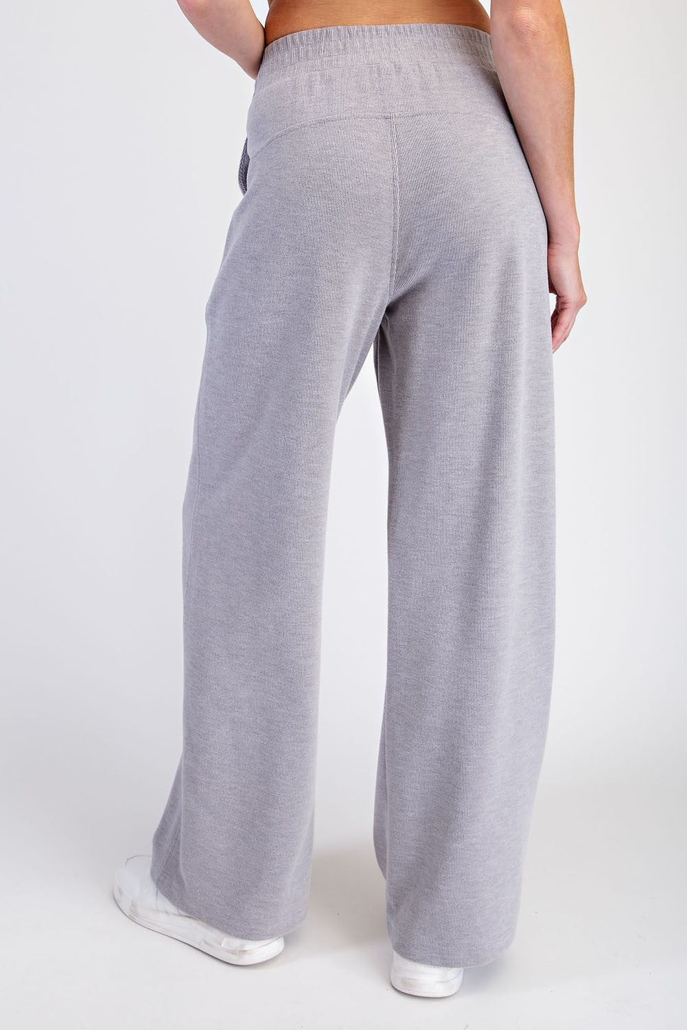 woman wearing light gray wide-leg lounge pants, back view, casual style