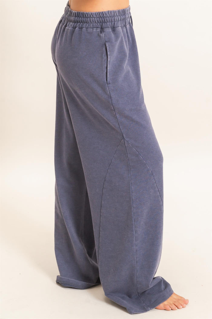 woman wearing navy blue wide-leg sweatpants with an elastic waistband and side pockets