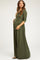 woman wearing a long olive green maternity dress with a wrap design and holding her baby bump