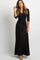 woman wearing a black long sleeve wrap maxi dress with a waist tie against a white background