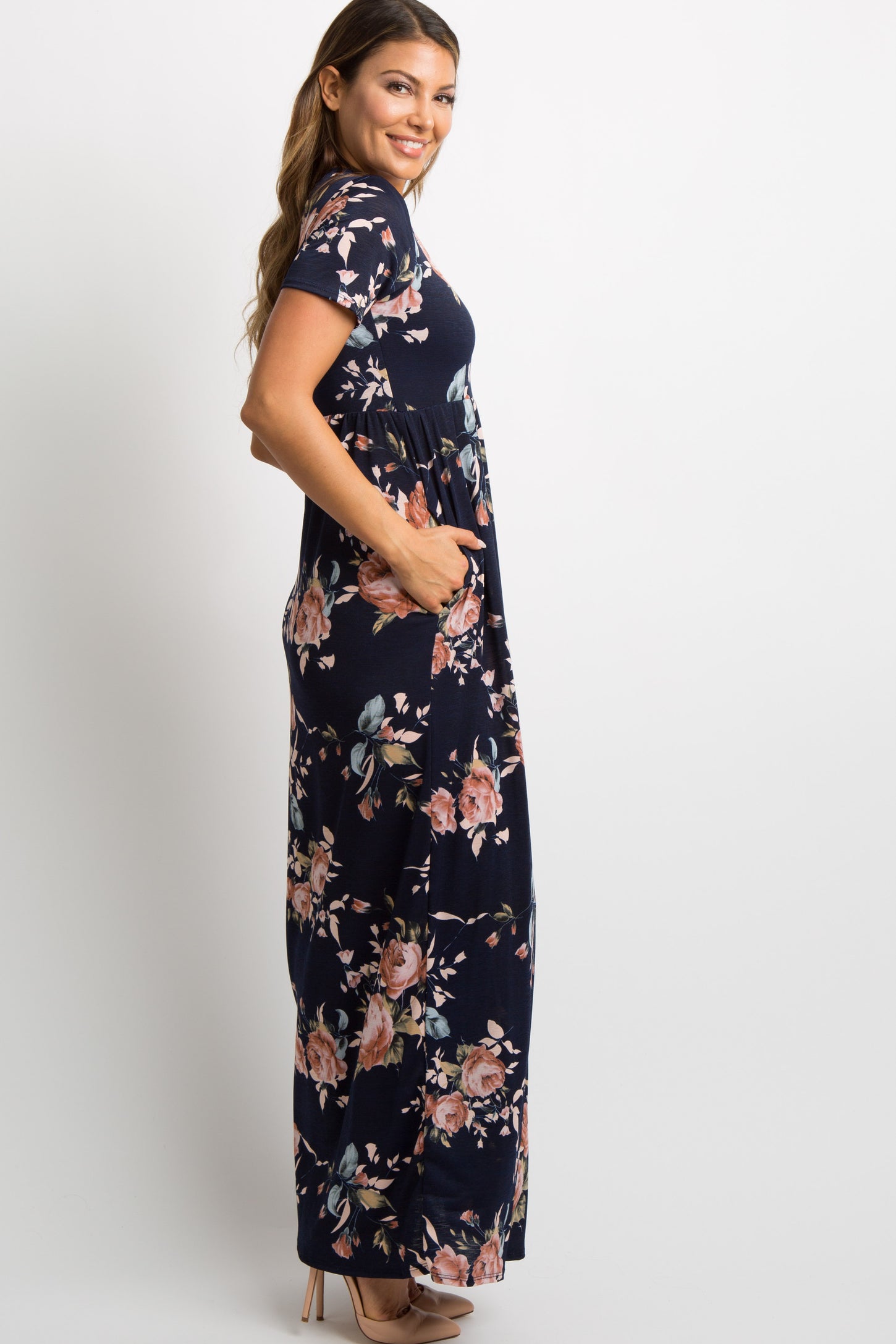 Pregnant woman wearing a navy blue floral print short sleeve maternity maxi dress