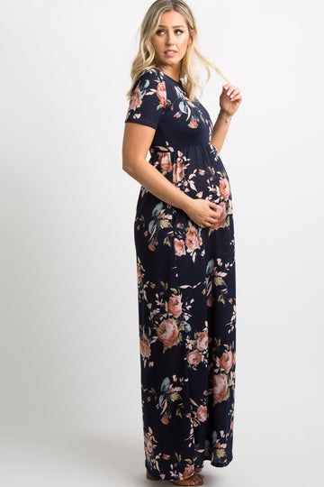 Pregnant woman wearing a navy blue floral print short sleeve maternity maxi dress