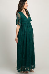 pregnant woman wearing a forest green lace maternity maxi dress with short sleeves and v-neckline