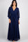 woman wearing a navy blue long sleeve wrap maxi dress with a waist tie against a white background
