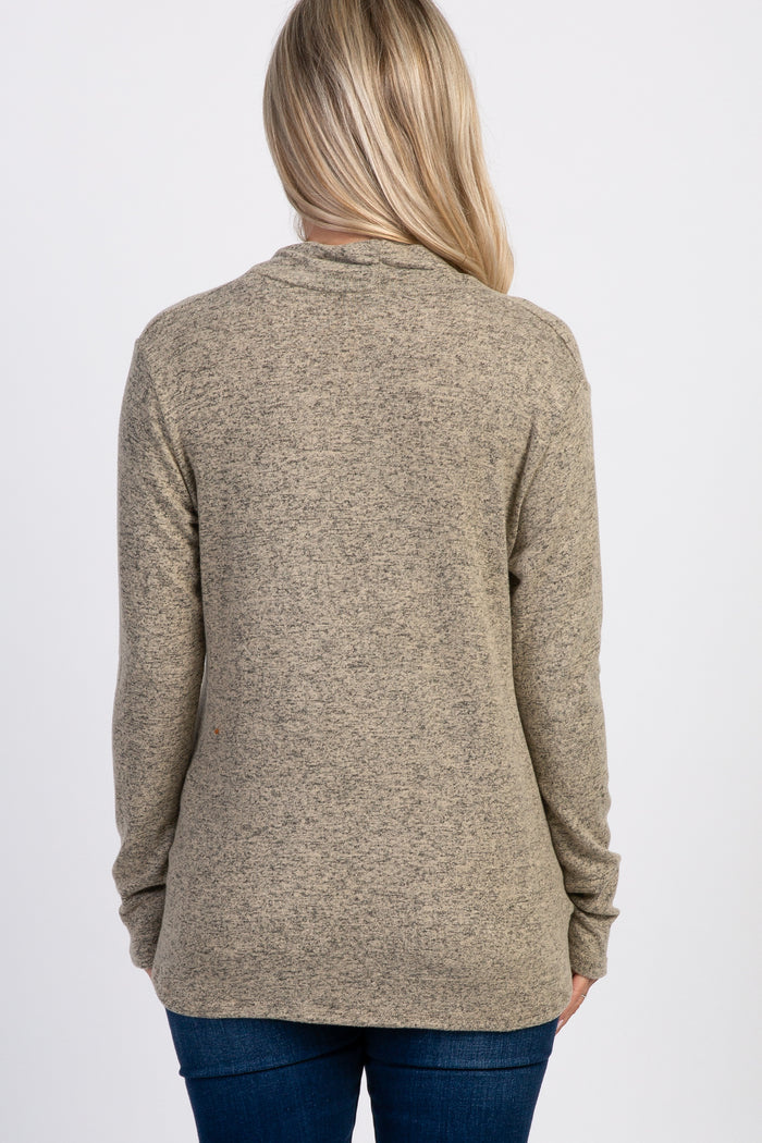 woman wearing a textured brown maternity top with long sleeves, shown from the back