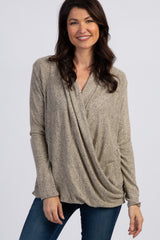 woman wearing a taupe cross-front long sleeve top with a relaxed fit and a stylish draped design