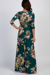 woman wearing a dark green floral maxi dress with three-quarter sleeves, shown from the back