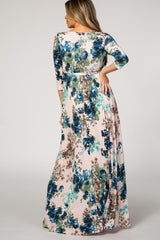 woman wearing a floral maxi dress with three-quarter sleeves in shades of blue and pink, seen from the back