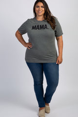woman wearing a grey mama graphic t-shirt and blue jeans standing against a white background