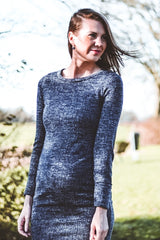 woman wearing a dark gray maternity long sleeve dress that highlights her baby bump