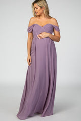 woman wearing a lavender off-the-shoulder maternity gown and holding her baby bump